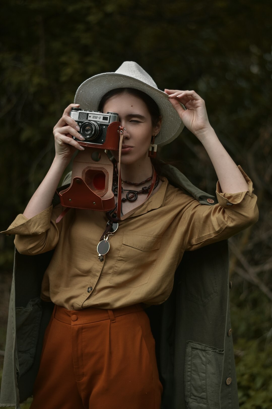 Danish documentary photographer holding a camera outdoors